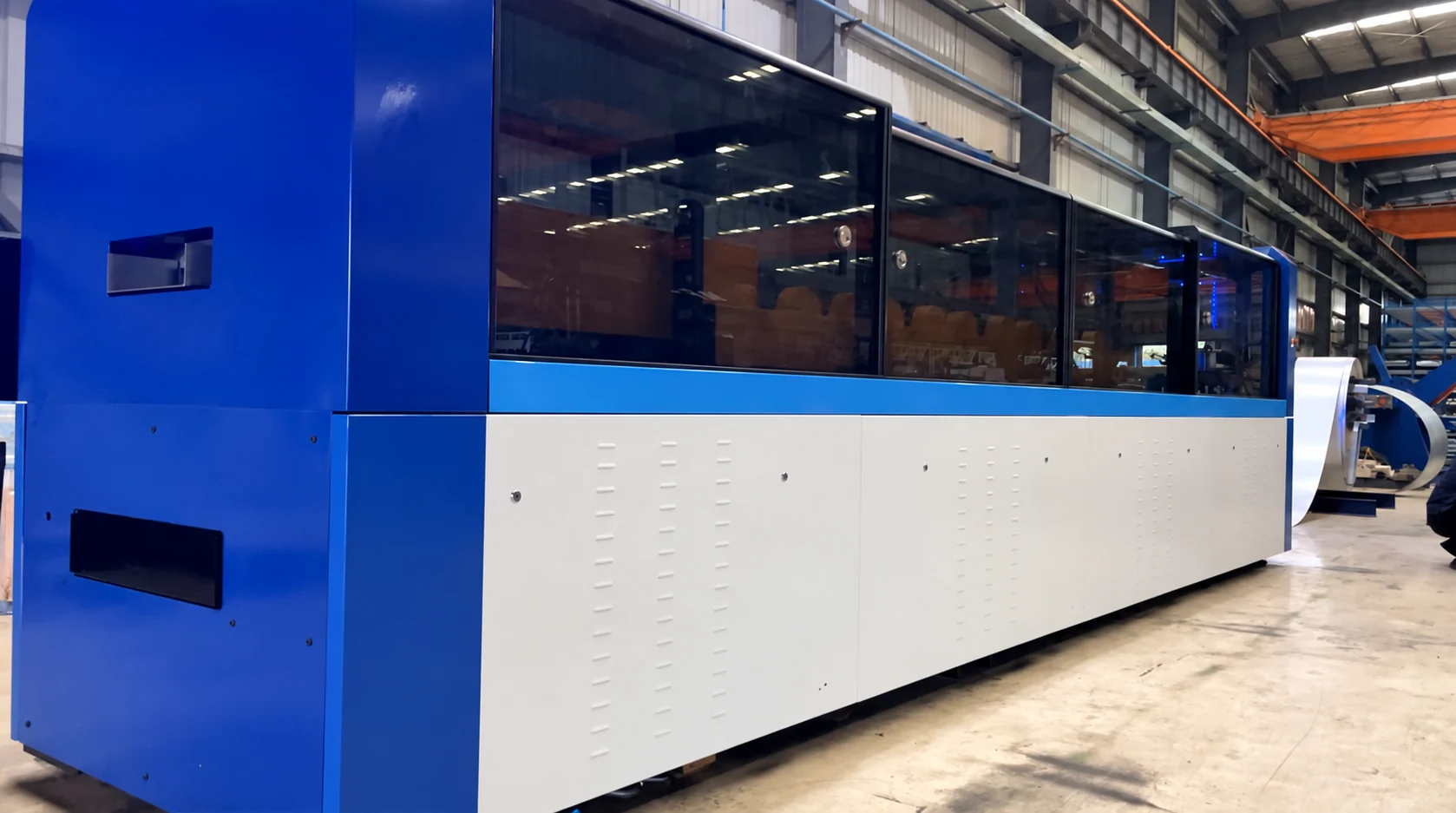 Blue enclosed HLG-300 light steel framing deck machine at our Xiamen production base