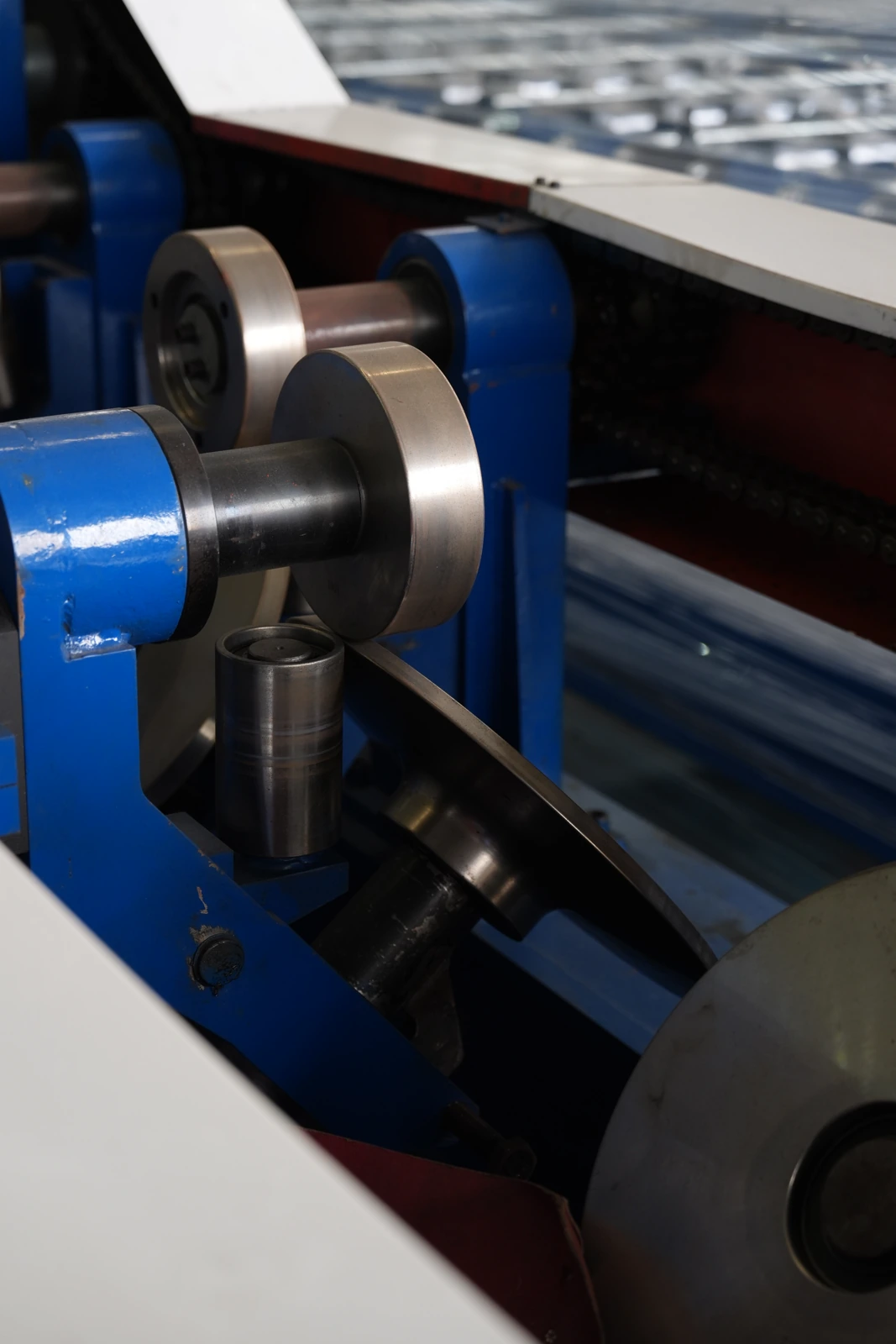 Close view of steel strip passing between rolls in our Xiamen production base
