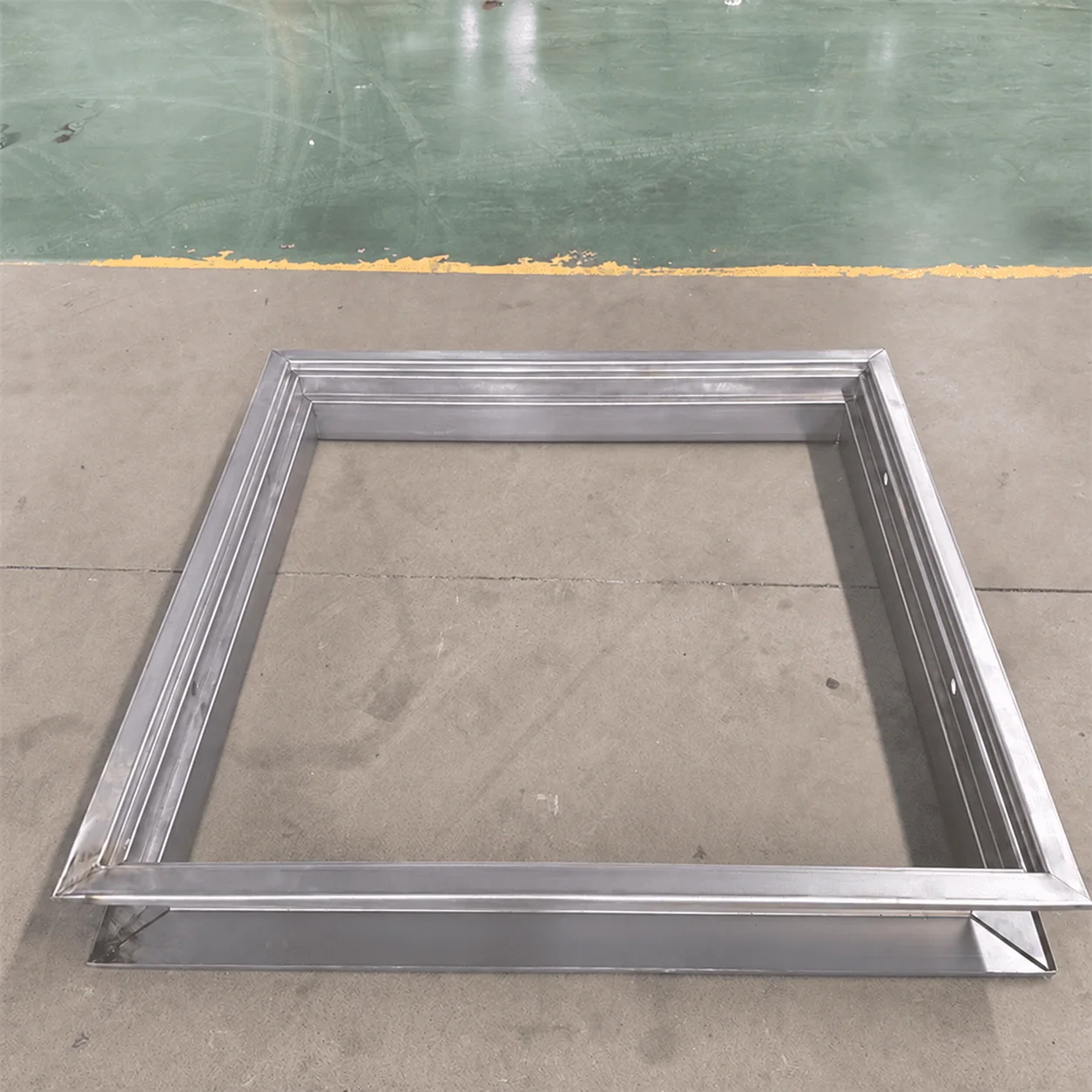 Assembled steel door-frame sample from our Xiamen production base showing the corner joint and formed section