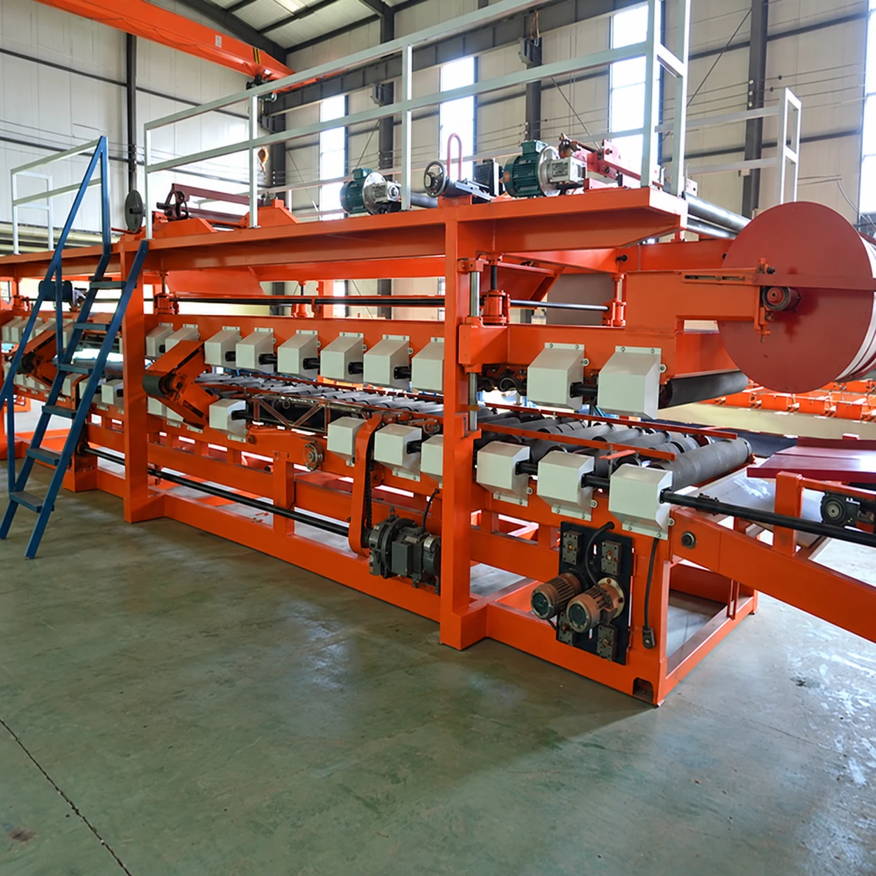Edited reference photograph of our Xiamen production base's orange EPS sandwich-panel production equipment in a workshop